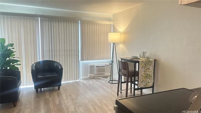 a living room with furniture and a lamp