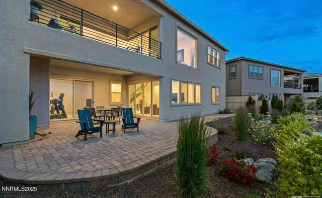 a living room with furniture a floor to ceiling window and a fireplace