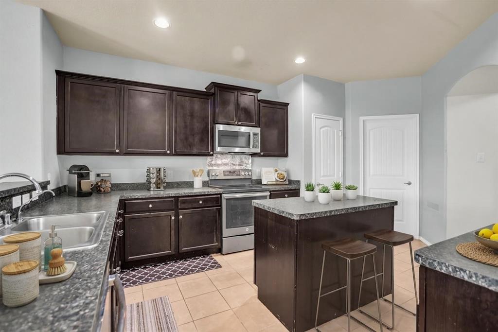 2114 Cedar Trail Anna, TX 75409 - Photo 14 of 34 a kitchen with a stove sink and microwave