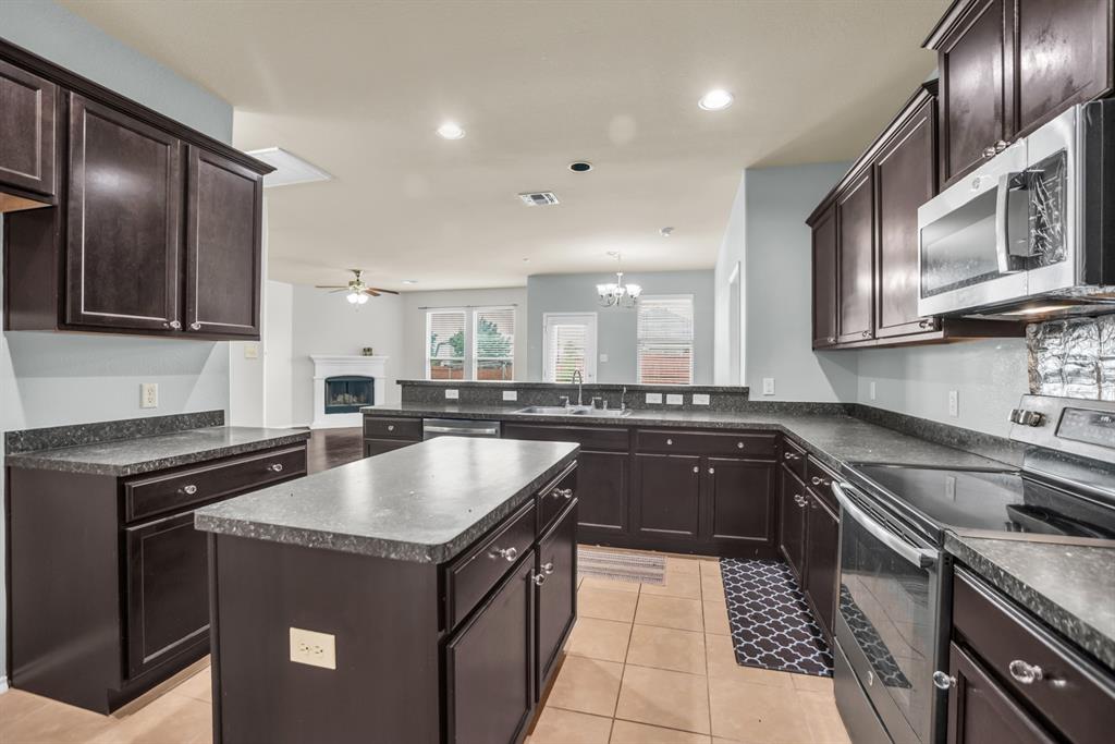 2114 Cedar Trail Anna, TX 75409 - Photo 16 of 34 a kitchen with a sink stove and microwave