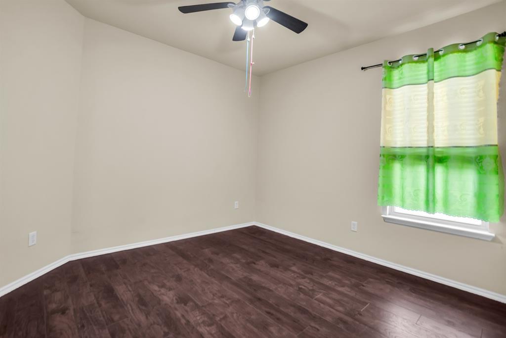 2114 Cedar Trail Anna, TX 75409 - Photo 17 of 34 a view of an empty room with a window and wooden floor