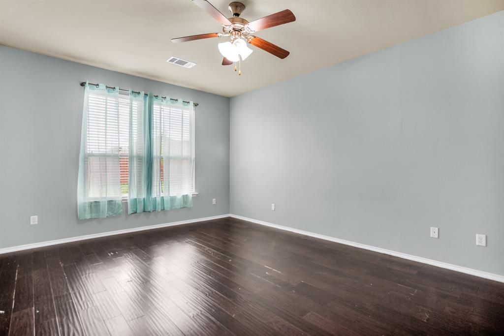 2114 Cedar Trail Anna, TX 75409 - Photo 24 of 34 an empty room with wooden floor fan and windows