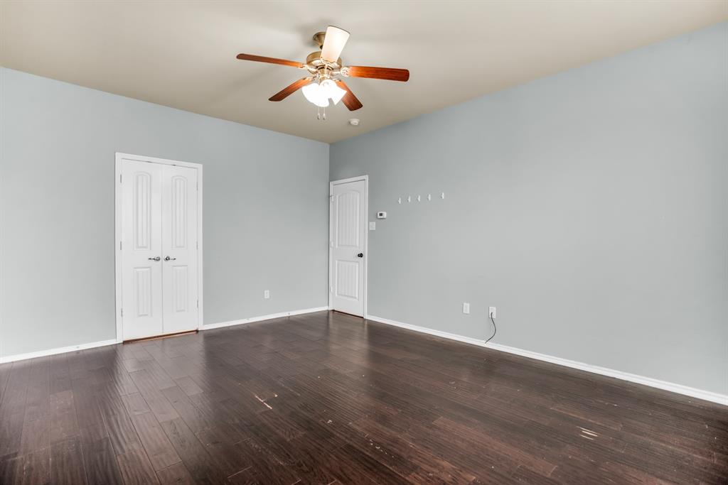 2114 Cedar Trail Anna, TX 75409 - Photo 26 of 34 an empty room with wooden floor and ceiling fan