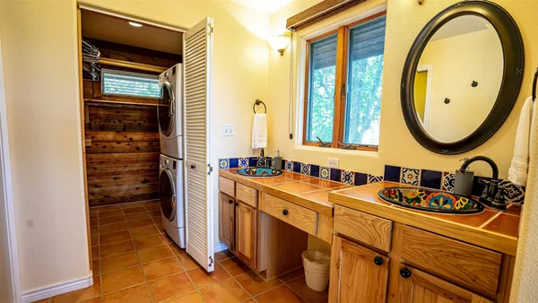 a bathroom with a sink a mirror and a window