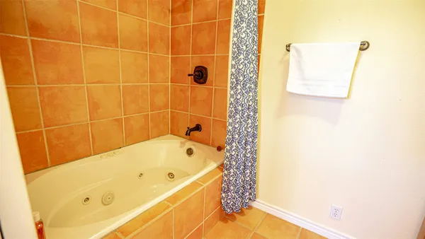 a bathroom with a bathtub and shower