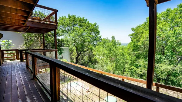 a view of balcony with wooden floor and outdoor seating