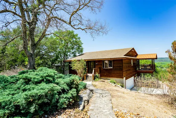 a view of a house with a backyard porch and sitting area