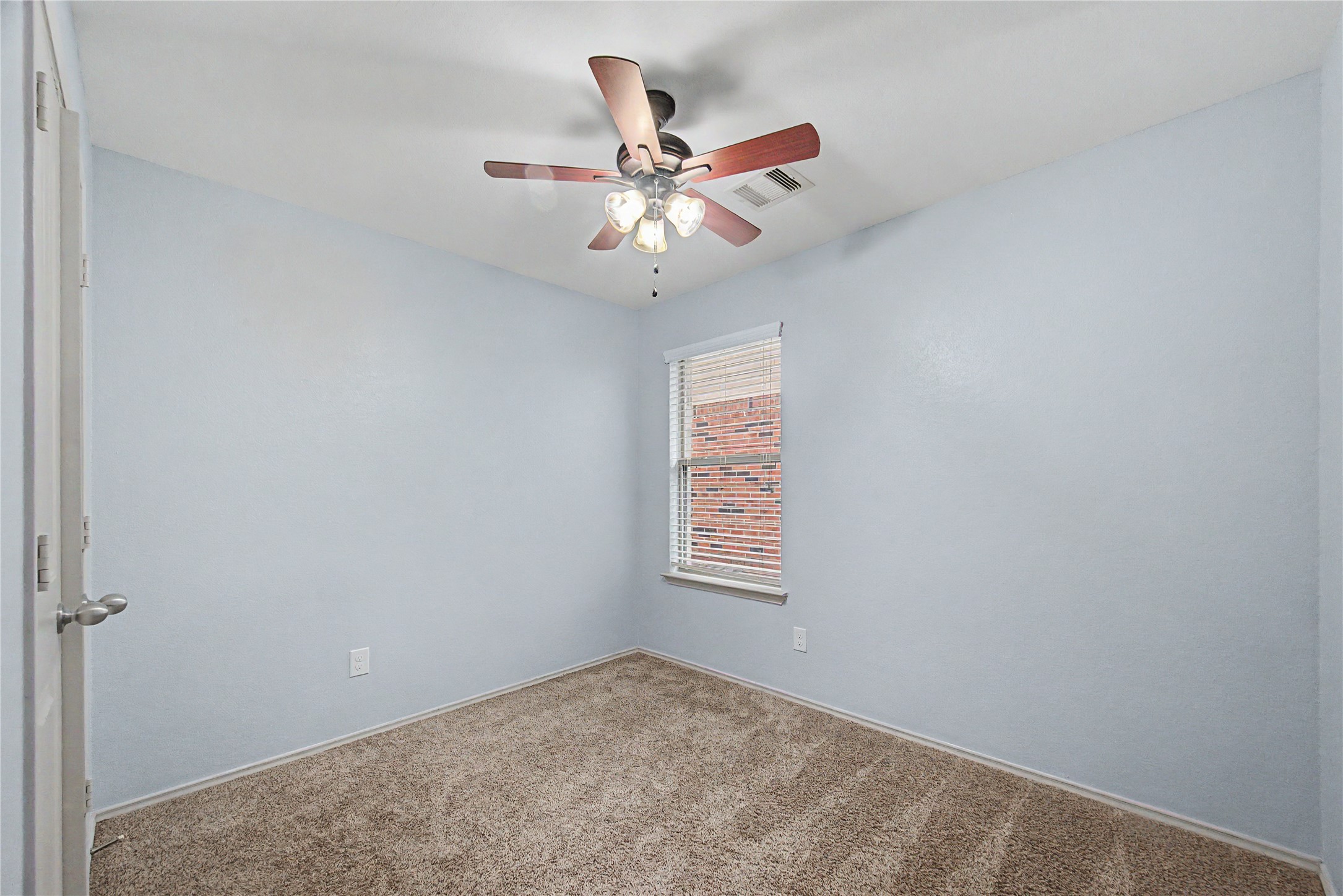 16430 Rodeo River Road Houston, TX 77049 - Photo 12 of 34 an empty room with a window and a ceiling fan