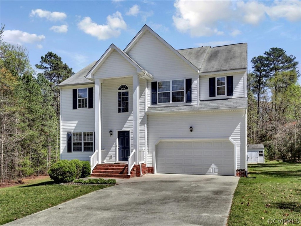 19907 Ivan Road Petersburg, VA 23803 - Photo 26 of 26 a front view of a house with a yard and a garage