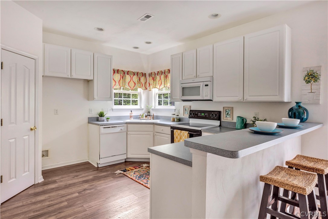 19907 Ivan Road Petersburg, VA 23803 - Photo 4 of 26 a kitchen with granite countertop white cabinets and white appliances