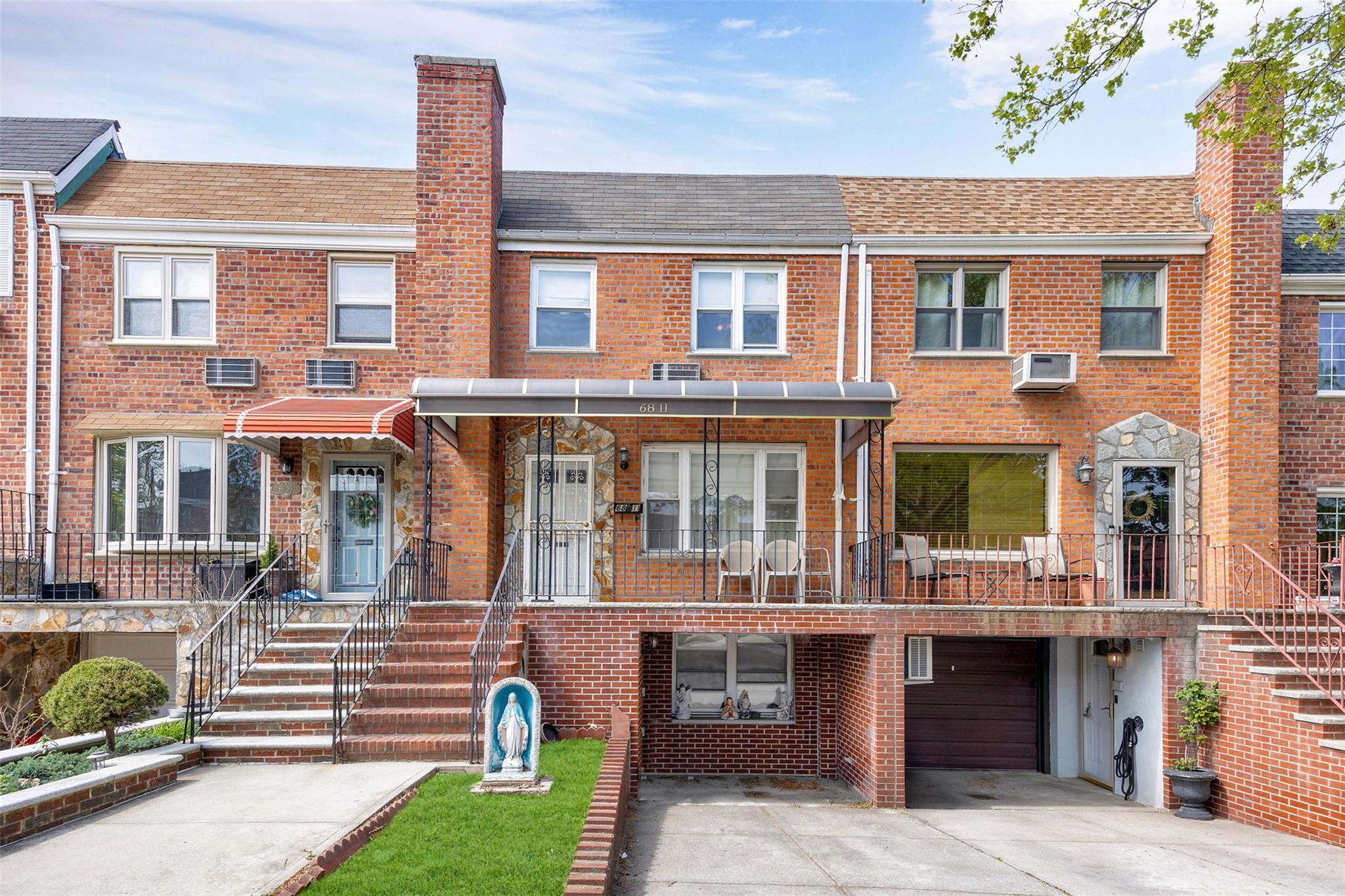 68-11 61st Road Queens, NY 11379 - Photo 1 of 1 a front view of multiple houses