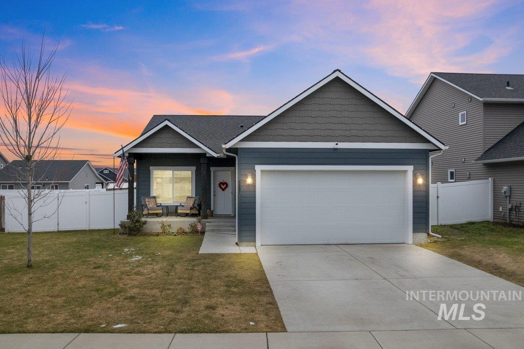 6697 West Irish Circle Rathdrum, ID 83858 - Photo 1 of 36 View of front of house with a gate, a porch, concrete driveway, and an attached garage