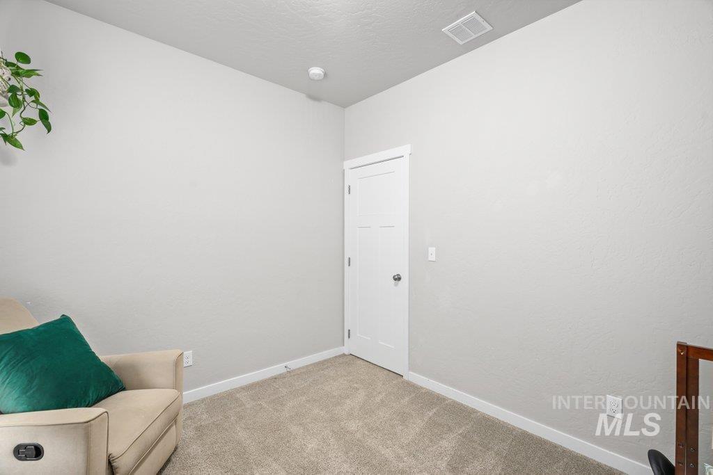 6697 West Irish Circle Rathdrum, ID 83858 - Photo 16 of 36 Sitting room featuring carpet, a textured ceiling, and a textured wall