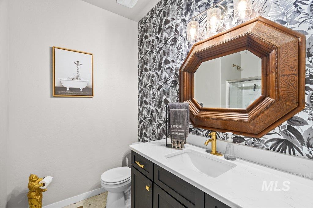 6697 West Irish Circle Rathdrum, ID 83858 - Photo 17 of 36 Bathroom featuring vanity, wallpapered walls, and a shower with shower door