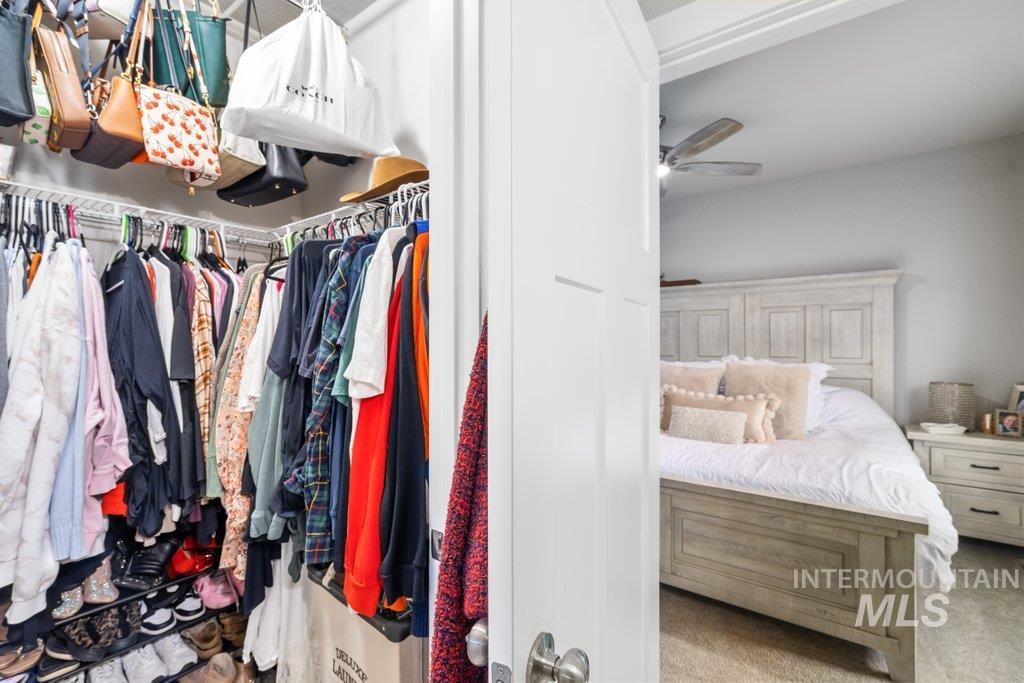 6697 West Irish Circle Rathdrum, ID 83858 - Photo 22 of 36 Walk in closet with light colored carpet and ceiling fan