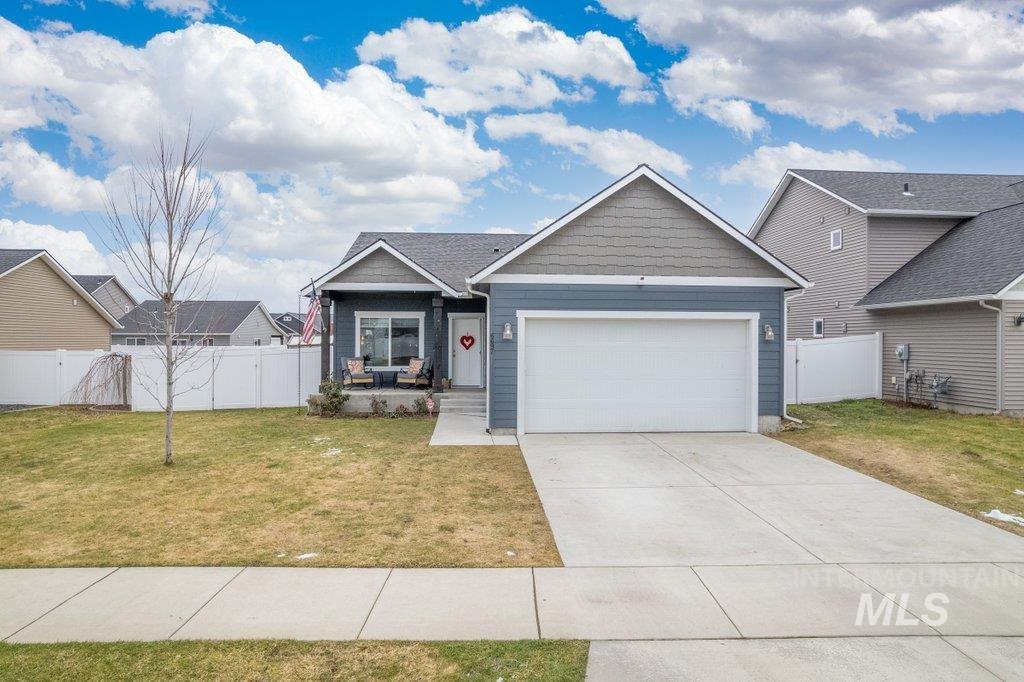 6697 West Irish Circle Rathdrum, ID 83858 - Photo 23 of 36 View of front of home with a gate, concrete driveway, an attached garage, and covered porch
