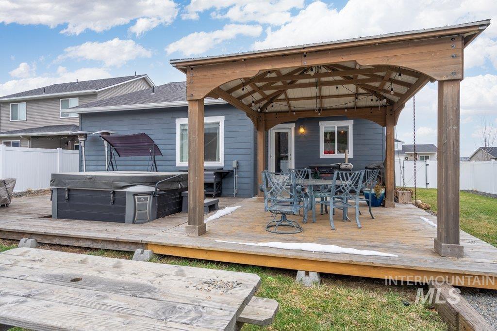 6697 West Irish Circle Rathdrum, ID 83858 - Photo 24 of 36 Deck with outdoor dining space, a hot tub, and a gazebo