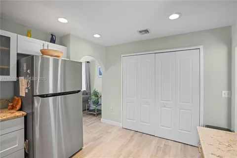 a view of a refrigerator in kitchen and wooden floor