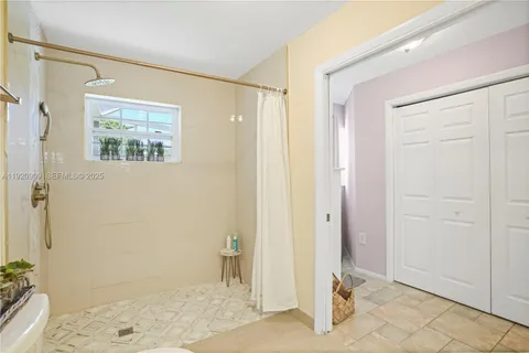 a view of a hallway with wooden floor and a livingroom view