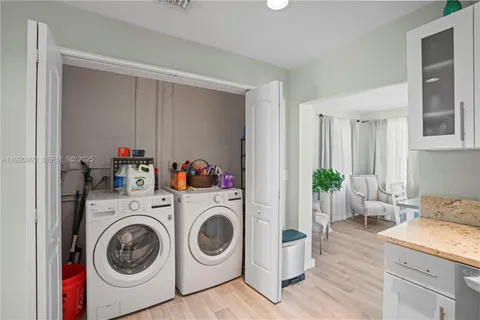 a utility room with sink dryer and washer