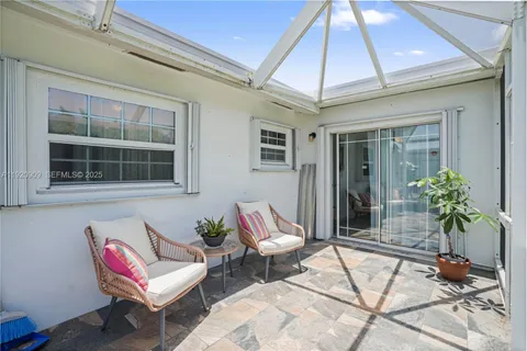 a building outdoor space with patio furniture and potted plants