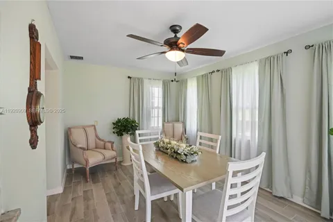 a view of a dining room with furniture and a window