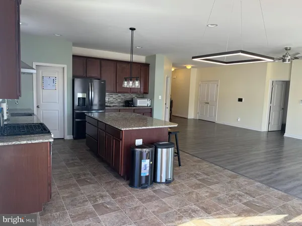 a kitchen with stainless steel appliances granite countertop a sink and a stove