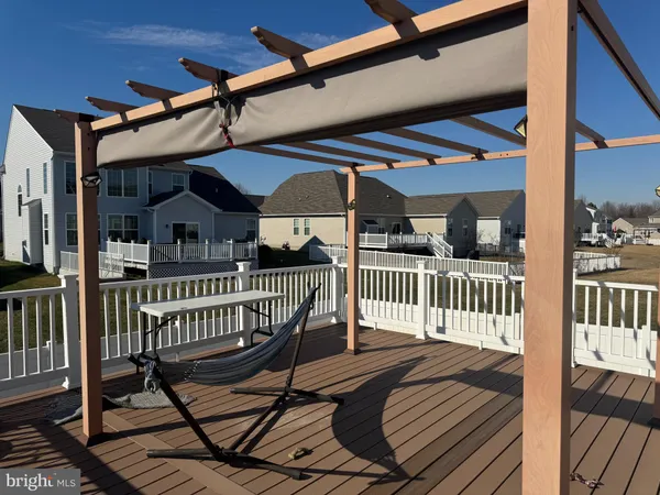 a view of a house with a deck and furniture