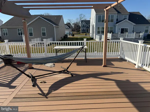 a view of a house with wooden deck and a yard