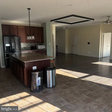 a kitchen with kitchen island a counter top space appliances and cabinets