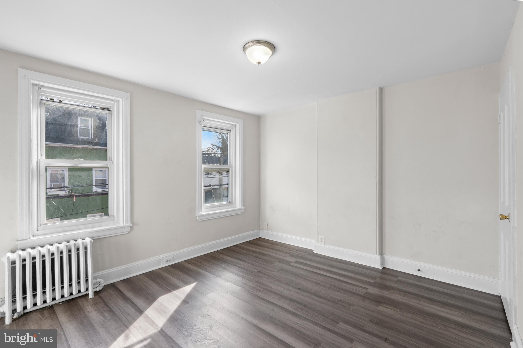 421 Mechanic Street Philadelphia, PA 19144 - Photo 13 of 20 a view of an empty room with wooden floor and a window