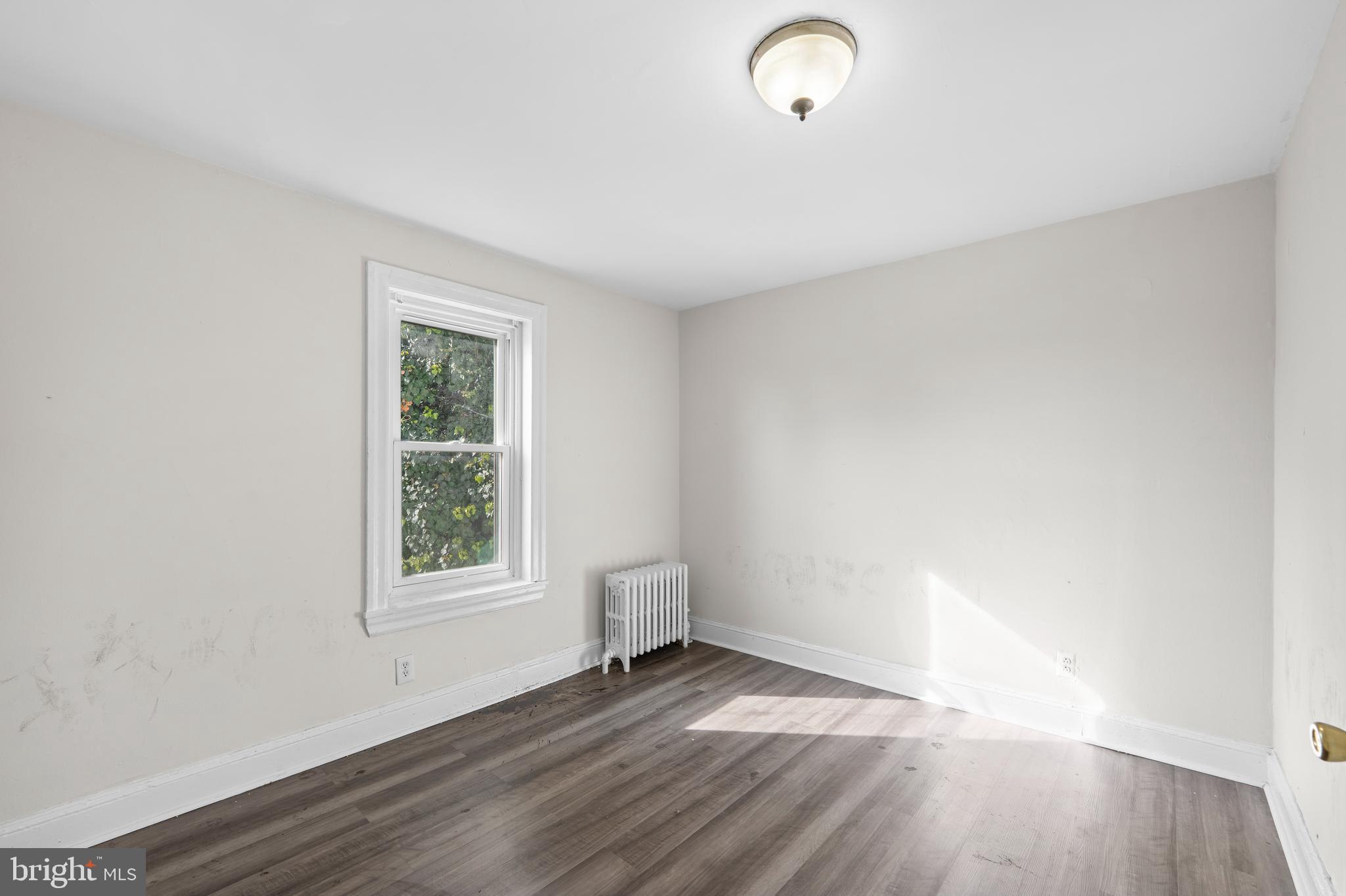 421 Mechanic Street Philadelphia, PA 19144 - Photo 15 of 20 an empty room with wooden floor and windows