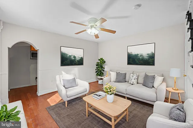 a living room with furniture a rug and a chandelier