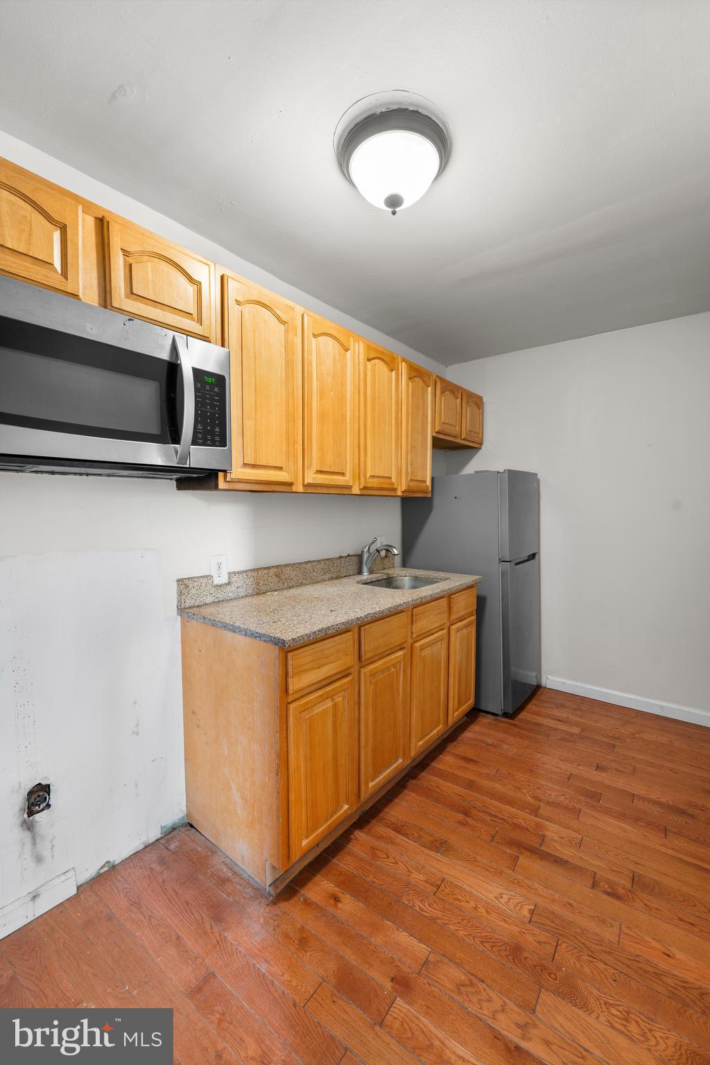 421 Mechanic Street Philadelphia, PA 19144 - Photo 5 of 20 a kitchen with stainless steel appliances granite countertop a sink and a microwave