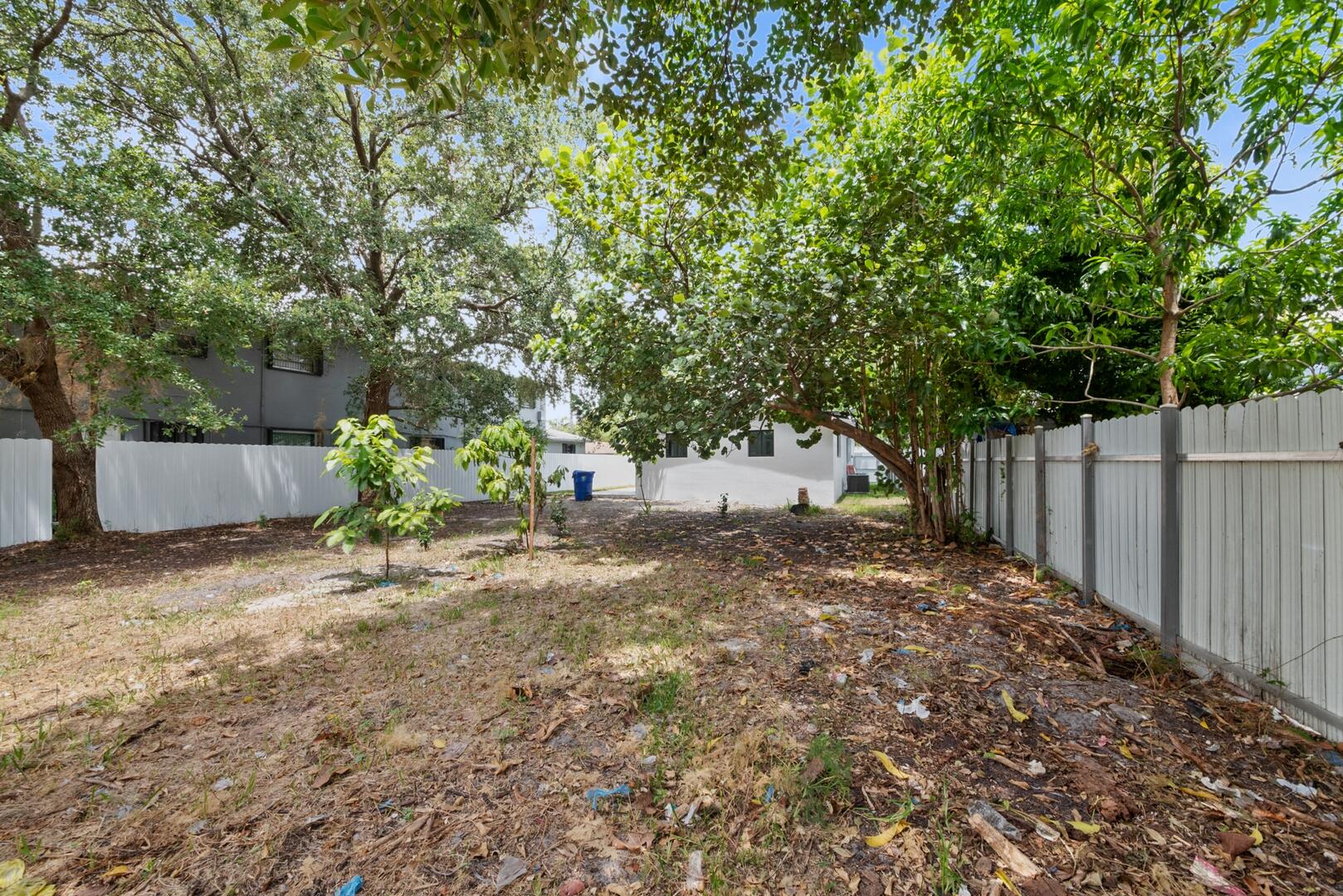 860 Northwest 70th Street Miami, FL 33150 - Photo 20 of 25 a view of a yard with large trees and a barn