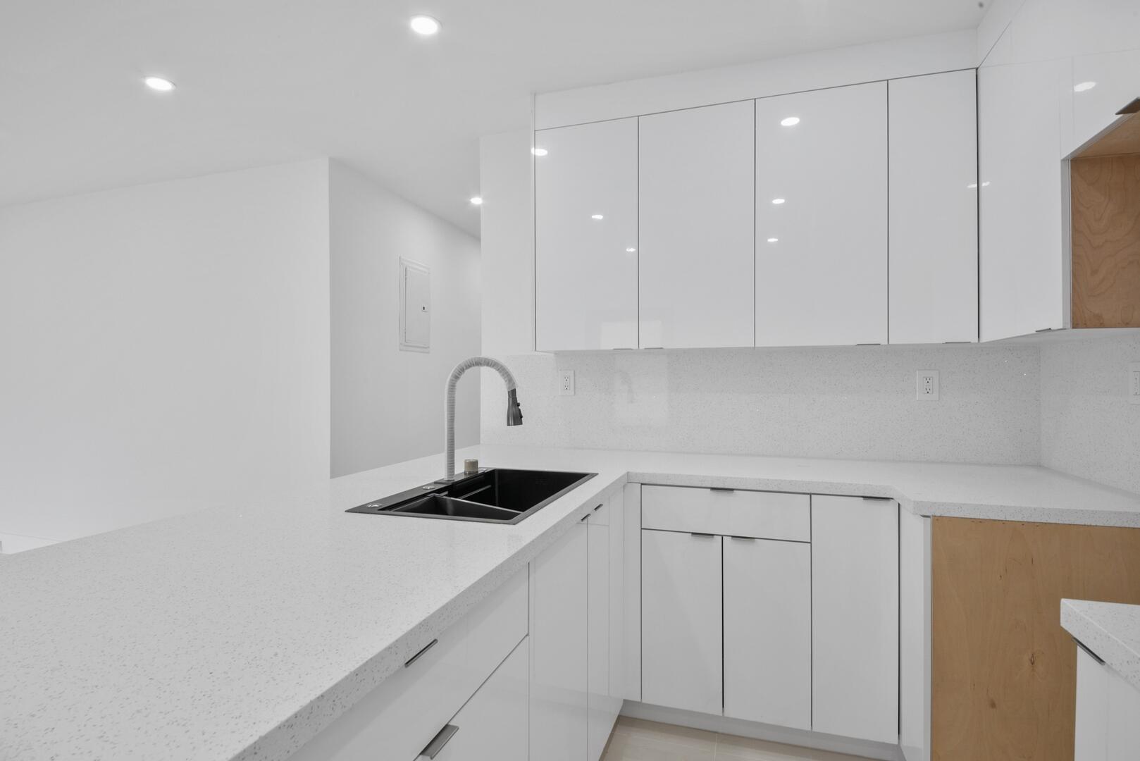 860 Northwest 70th Street Miami, FL 33150 - Photo 7 of 25 a kitchen with white cabinets and appliances