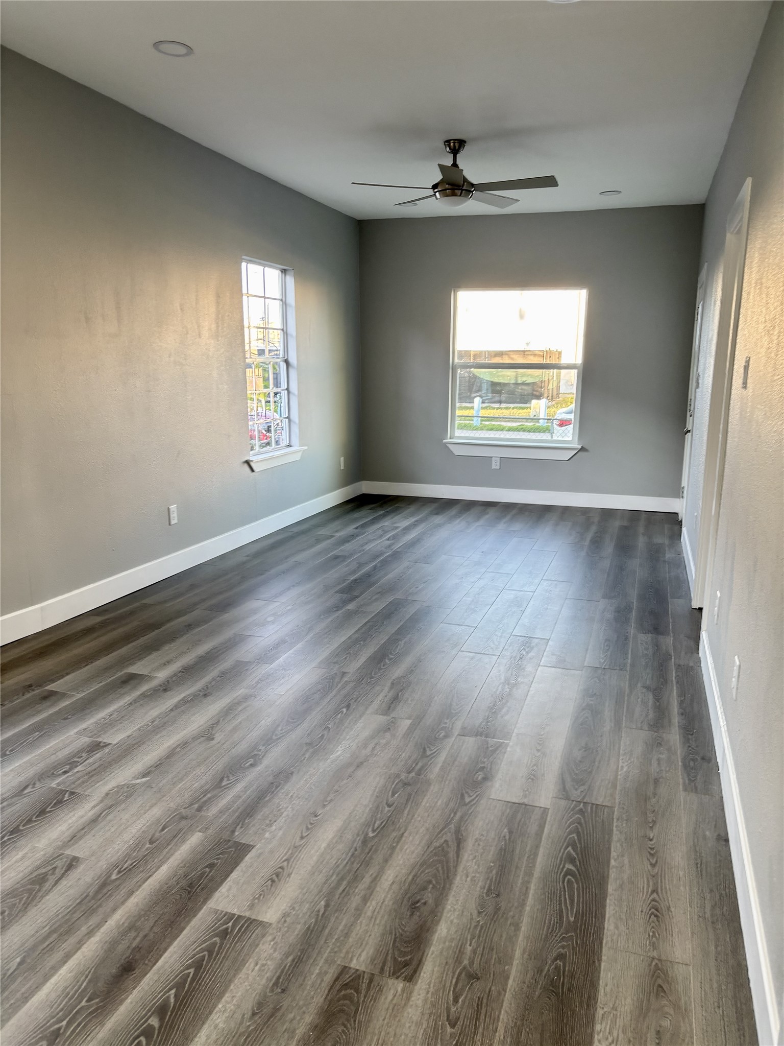 2007 Spring Street Houston, TX 77007 - Photo 8 of 18 a view of an empty room with wooden floor and a window