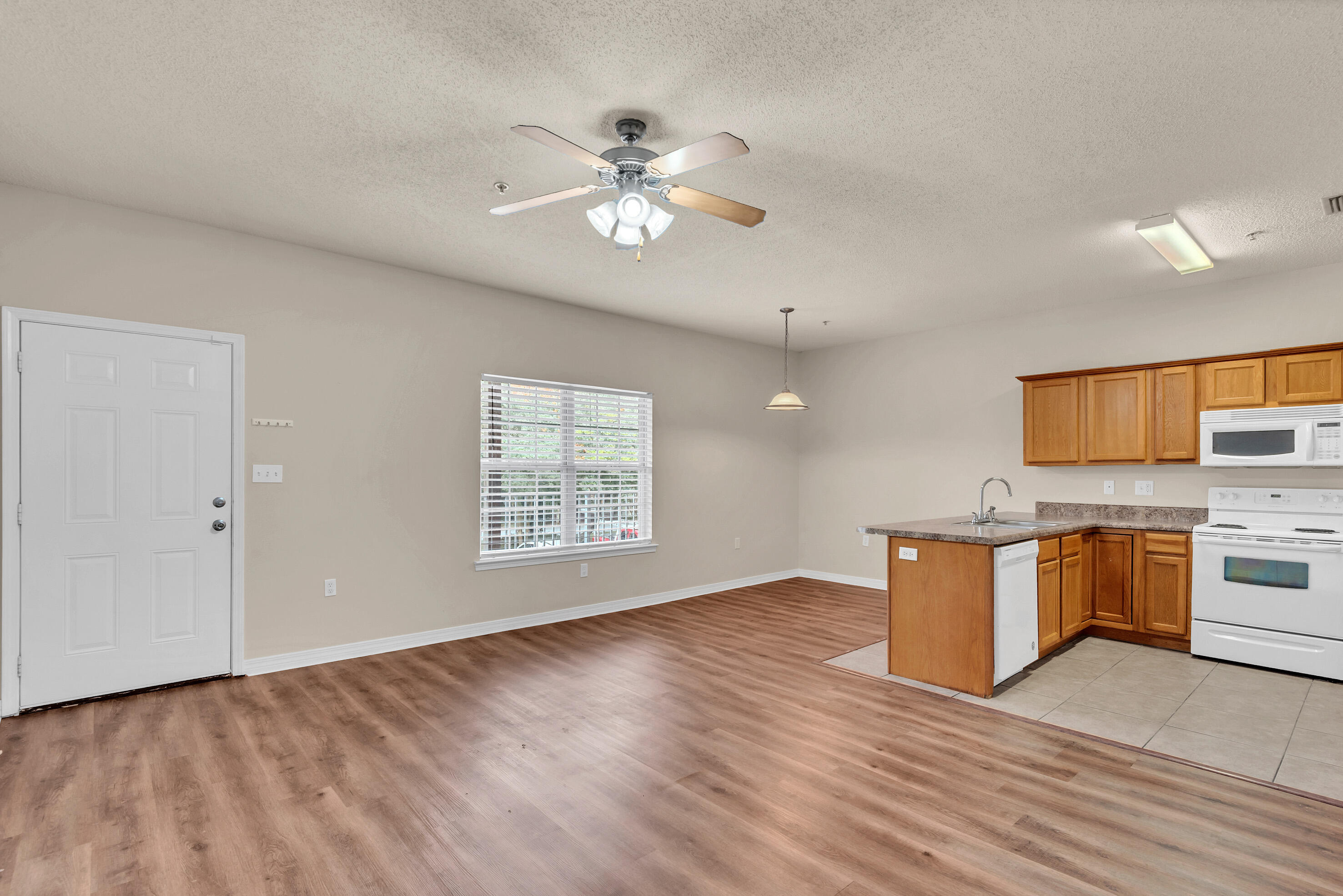 936 Barrow Street, Unit 7 Fort Walton Beach, FL 32547 - Photo 4 of 9 a view of a kitchen with a sink cabinets and wooden floor