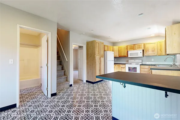 a kitchen with refrigerator and window