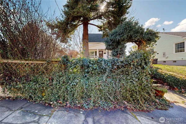 a front view of a house with a yard and fountain