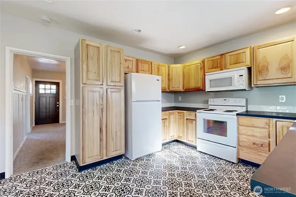 a kitchen with stainless steel appliances granite countertop a refrigerator and a stove