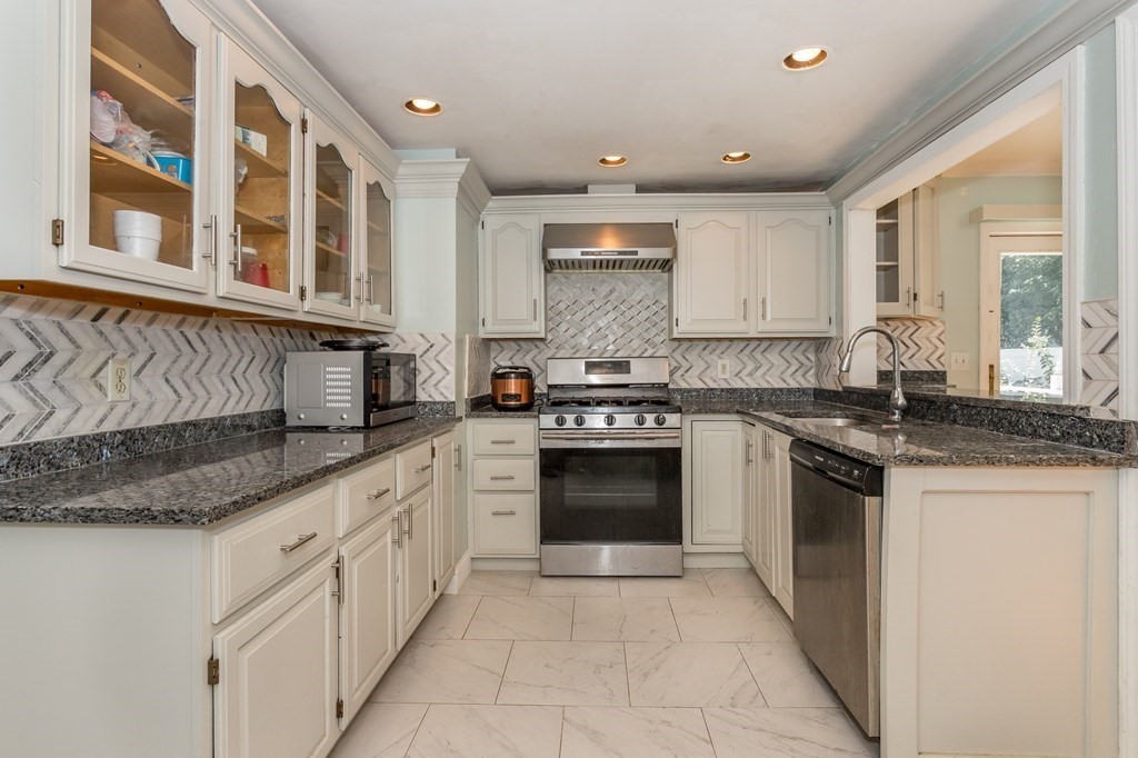 59 Weyham Road Weymouth, MA 02191 - Photo 3 of 18 a kitchen with stainless steel appliances granite countertop a stove and a sink