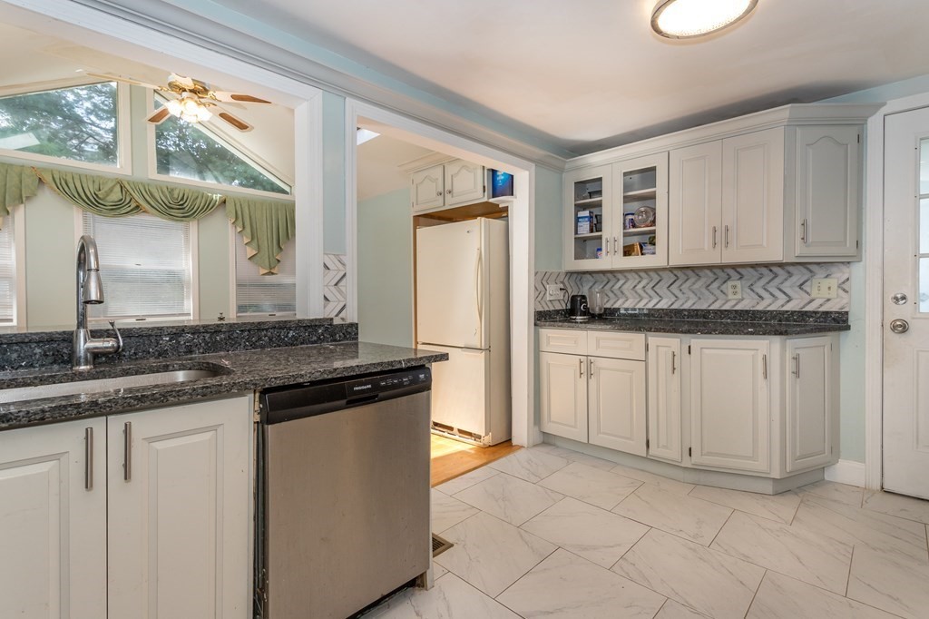 59 Weyham Road Weymouth, MA 02191 - Photo 4 of 18 a kitchen with granite countertop a sink and a refrigerator