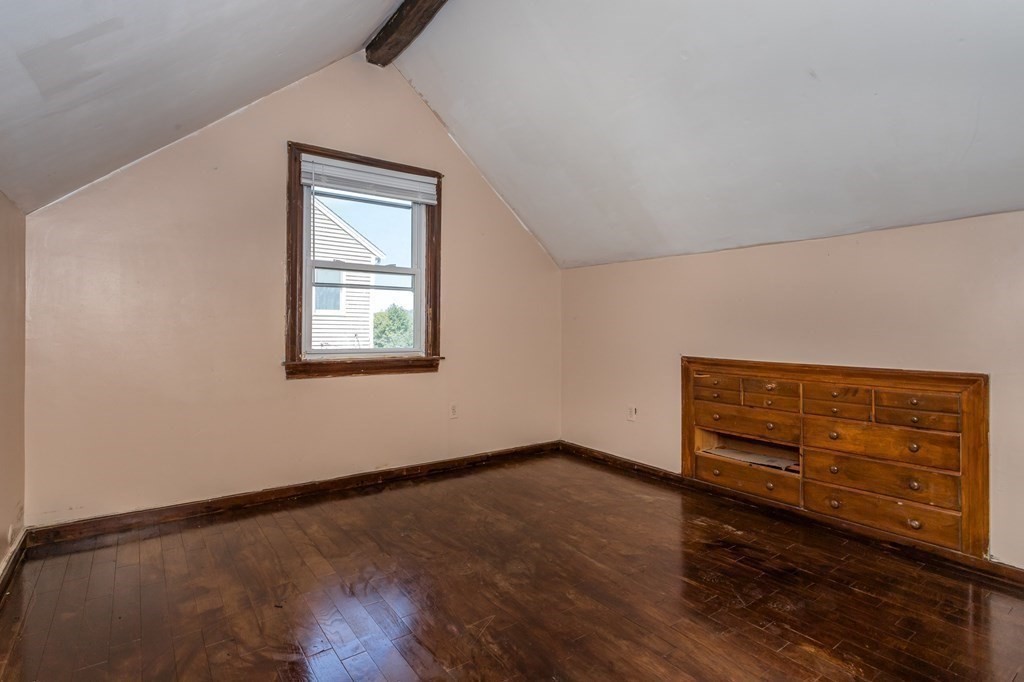 59 Weyham Road Weymouth, MA 02191 - Photo 7 of 18 a view of an empty room with wooden floor and a window
