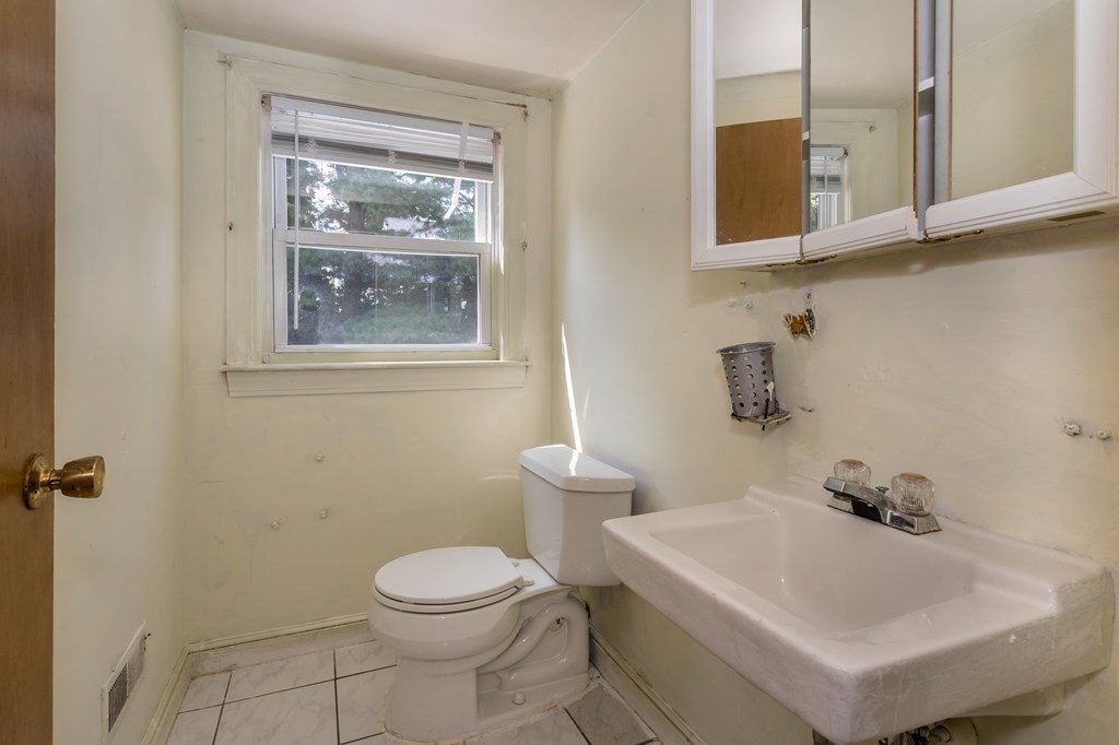 59 Weyham Road Weymouth, MA 02191 - Photo 9 of 18 a bathroom with a sink a toilet and mirror