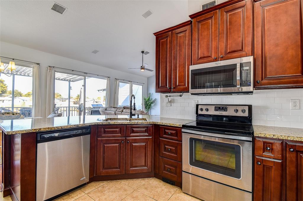 5309 Boardwalk Street Holiday, FL 34690 - Photo 15 of 50 a kitchen with a sink stove and microwave