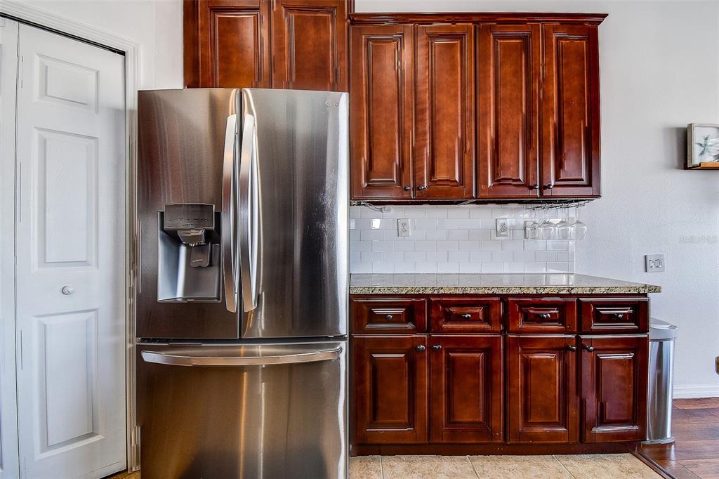 5309 Boardwalk Street Holiday, FL 34690 - Photo 16 of 50 a kitchen with stainless steel appliances granite countertop a refrigerator and a sink