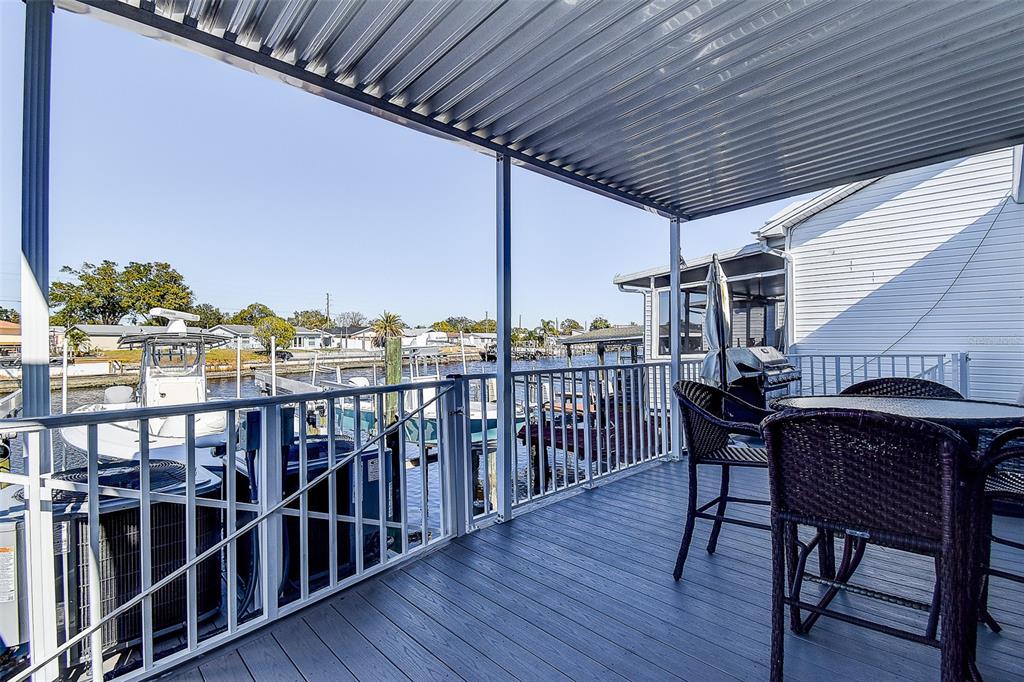 5309 Boardwalk Street Holiday, FL 34690 - Photo 22 of 50 a view of a chairs and table on the deck