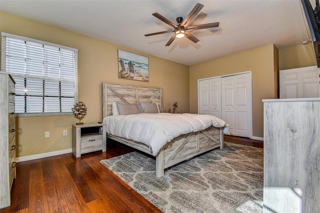 5309 Boardwalk Street Holiday, FL 34690 - Photo 27 of 50 a bedroom with a bed and a chandelier