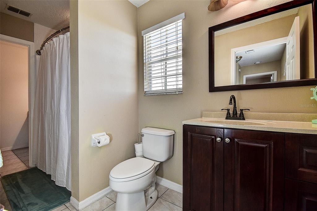 5309 Boardwalk Street Holiday, FL 34690 - Photo 32 of 50 a bathroom with a toilet sink and mirror